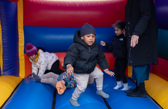 Young children playing on a bouncy castle