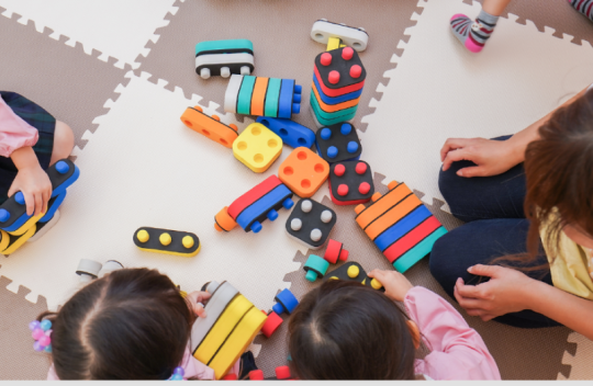 Children playing with toys on a mat